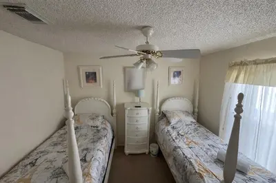 a bedroom with two beds and a ceiling fan at 4813 Pliny Court in Kissimmee