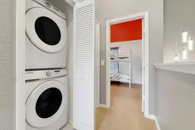 a white laundry room with a washer and dryer at Disney Min Away - Pool Patio & BBQ in Orlando
