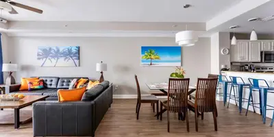 a living room with a couch and a table with chairs at Blue Heron Resort in Orlando