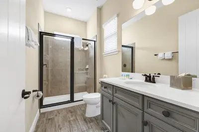 a bathroom with a toilet and a sink and a shower at Tropical Cottage With Hot Tub Near Disney With Margaritaville Resort And Island H20 Waterpark Access - 8040Dr in Orlando