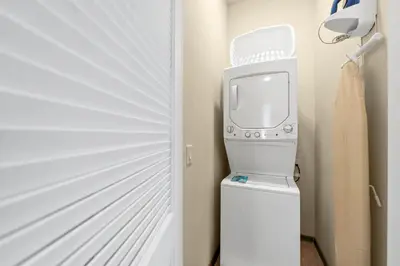 a tv sitting on top of a toilet next to a door at Tropical Cottage With Hot Tub Near Disney With Margaritaville Resort And Island H20 Waterpark Access - 8040Dr in Orlando