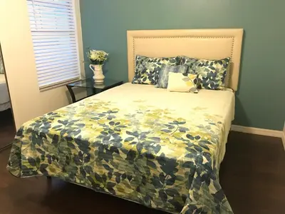 a bedroom with a bed with a camouflage bedspread at 10 minutes to all Disney park for vacation in Kissimmee