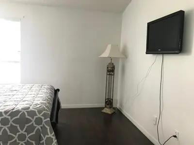 a bedroom with a bed and a flat screen tv on the wall at 10 minutes to all Disney park for vacation in Kissimmee