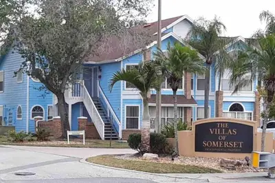 a blue house with a sign in front of it at 10 minutes to all Disney park for vacation in Kissimmee