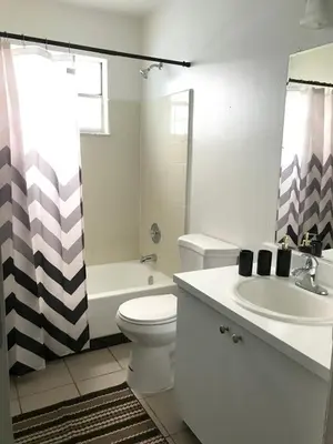 a bathroom with a sink and a toilet and a shower at 10 minutes to all Disney parks with pool and wifi in Kissimmee