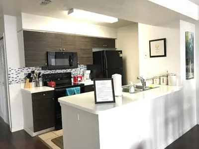 a kitchen with a counter top and a kitchen with a stove at 10 minutes to all Disney parks with pool and wifi in Kissimmee