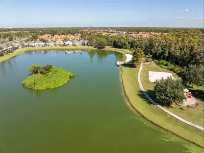 an aerial view of a lake with islands in it at Peaceful Palms Stay for 6 in Kissimmee