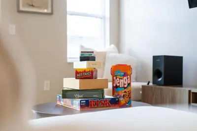 a stack of books sitting on top of a table at Peaceful Palms Stay for 6 in Kissimmee