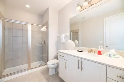 a bathroom with a shower and a toilet and a sink at 7484 Marker Avenue in Orlando