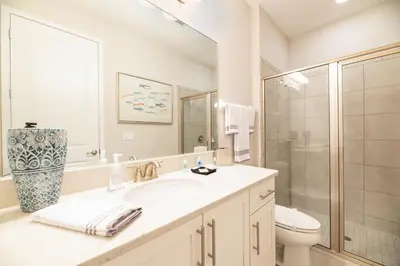a bathroom with a sink and a toilet and a shower at 7484 Marker Avenue in Orlando