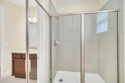 a shower with a glass door in a bathroom at 7503 Marker Avenue in Orlando