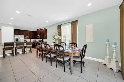 a dining room and kitchen with a table and chairs at 7503 Marker Avenue in Orlando