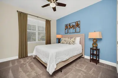 a bedroom with a bed and a ceiling fan at 7503 Marker Avenue in Orlando