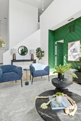 a living room with two blue chairs and a table at Freshly Updated Near Disney Private Pool Resort in Kissimmee