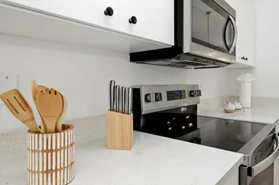 a kitchen with a counter with a stove top oven at Freshly Updated Near Disney Private Pool Resort in Kissimmee