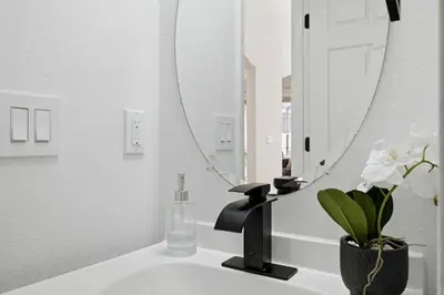 a bathroom with a sink and a mirror at Freshly Updated Near Disney Private Pool Resort in Kissimmee