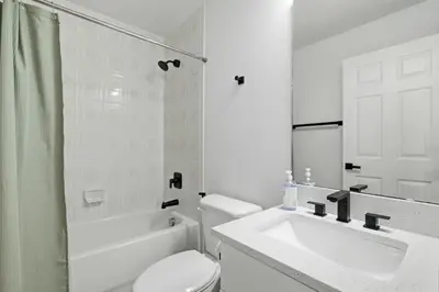 a white bathroom with a sink and a toilet at Freshly Updated Near Disney Private Pool Resort in Kissimmee