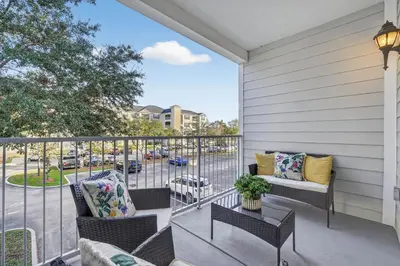 a balcony with furniture and a view of a street at 3176-205 Resort Pool Condo Apt near Disney in Kissimmee