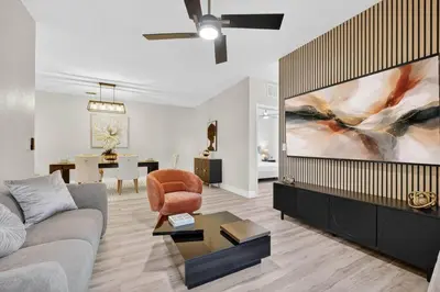 a living room with a couch and a tv at 3176-205 Resort Pool Condo Apt near Disney in Kissimmee