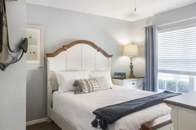 a bedroom with a large white bed with a large window at Family Private Home W Heated Pool 12Min To Walt Disney in Kissimmee