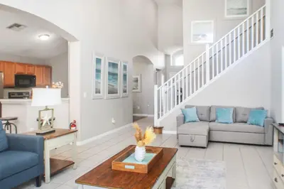 a living room with a couch and a table at Family Private Home W Heated Pool 12Min To Walt Disney in Kissimmee