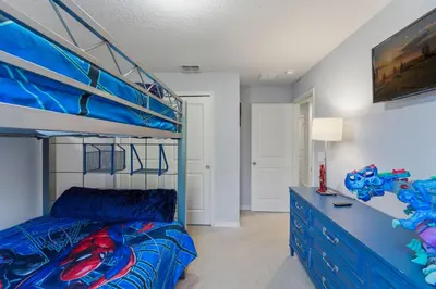 a bedroom with a bunk bed and a blue bed at Savvy 4Bed Stay Near Orlando Attractions in Kissimmee