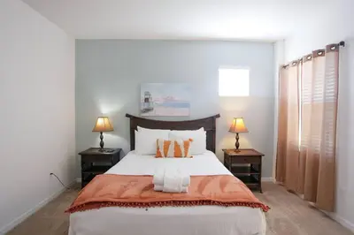 a bedroom with a large bed with two night stands at Spacious Home - Veranda Palms w Heated Pool & BBQ in Kissimmee
