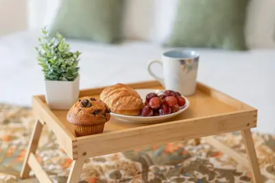 a wooden table with a muffin and a plate of fruit at Lakefront Home Game Room & Views in Kissimmee