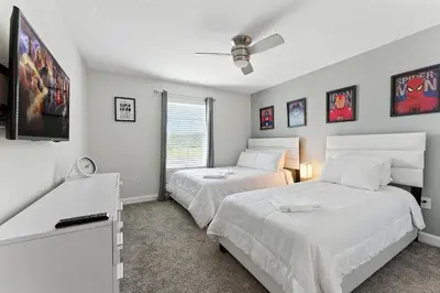 a bedroom with two beds and a flat screen tv at Townhome 4Q c/ Piscina Privativa no Storey Lake in Kissimmee