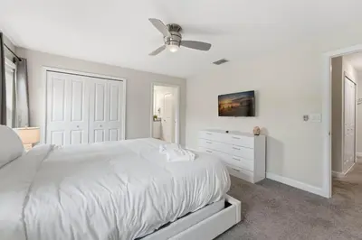 a white bedroom with a white bed and a dresser at Townhome 4Q c/ Piscina Privativa no Storey Lake in Kissimmee