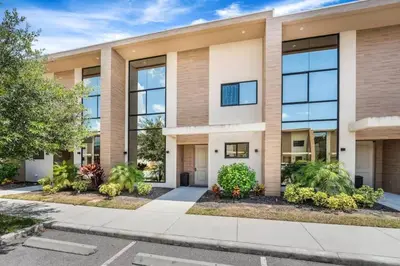 an apartment building with large windows at Magic Villa - 4 En-Suite & BBQ Grill in Orlando