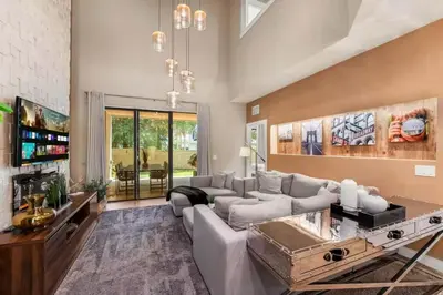 a living room with a couch and a tv at Magic Villa - 4 En-Suite & BBQ Grill in Orlando