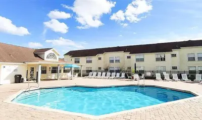 a large swimming pool in front of a building at Cozy Ground Floor Studio Near Disney in Kissimmee