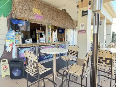 a table and chairs in front of a restaurant at 4 Bedroom 3 Bathroom Villas At Seven Dwarfs 24-101 in Kissimmee