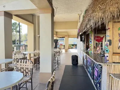 a restaurant with tables and chairs and a bar at 4 Bedroom 3 Bathroom Villas At Seven Dwarfs 24-101 in Kissimmee