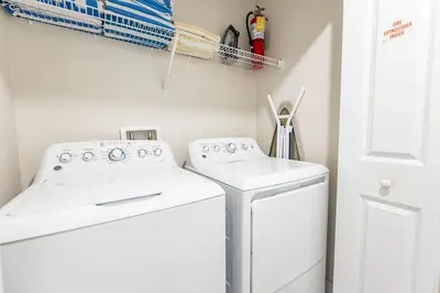a laundry room with a washer and dryer at 4BR Townhome w Pool in Storey Lake - Near Disney in Kissimmee