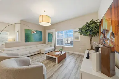 a living room with a couch and a table at Cozy 5 Bedrooms and 4 Bathrooms At Storey Lake in Kissimmee