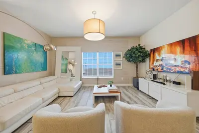 a living room with a couch and a table at Cozy 5 Bedrooms and 4 Bathrooms At Storey Lake in Kissimmee