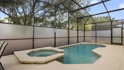 a swimming pool in a building with a glass ceiling at Upstay Spacious Villa w Pool, Hot Tub & Game Room in Kissimmee