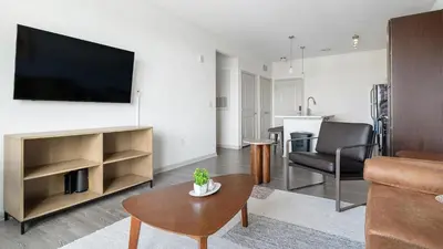 a living room with a flat screen tv and a couch at Landing Stunning 1BD Gym Clubhouse in Orlando