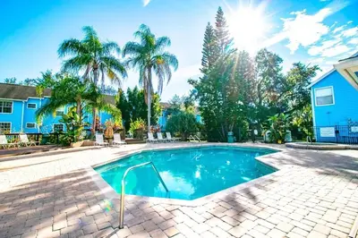 a swimming pool in a yard with palm trees at 10min to Disney parks new condo free wifi & pool in Kissimmee