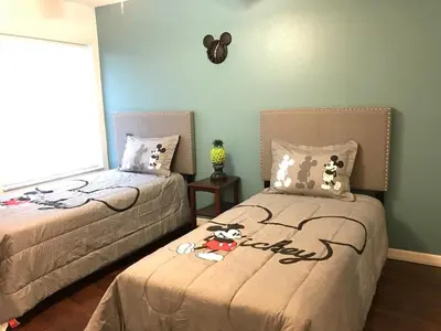 a bedroom with two beds with stuffed animals on them at 10min to Disney parks new condo free wifi & pool in Kissimmee