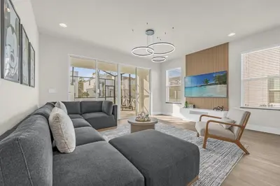 a living room with a couch and a chair at Luxury 4 Bedroom Family Getaway w Private Pool in Orlando