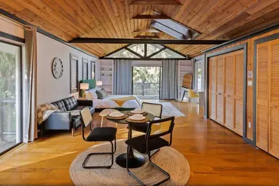 a living room with a couch and a table at Romantic Getaway Cabin with Jacuzzi in Kissimmee