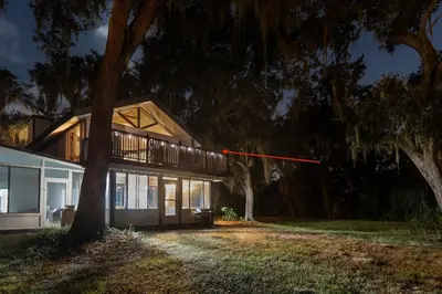 a house with a red line in front of it at Romantic Getaway Cabin with Jacuzzi in Kissimmee