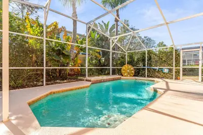 an indoor swimming pool in a building with a glass wall at The Art House Home for 8 in Orlando