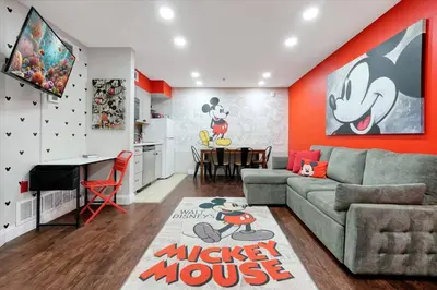 a living room with a couch and a table at Mickey Family Condo - 4 Miles to Disney in Orlando