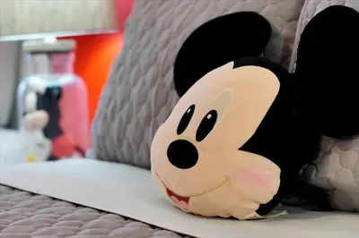 a toy animal is sitting on a bed at Mickey Family Condo - 4 Miles to Disney in Orlando
