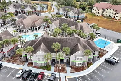an aerial view of a house with cars parked in a parking lot at Mickey Family Condo - 4 Miles to Disney in Orlando