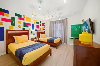 a bedroom with two beds and a colorful wall at Cozy Home Luxury 04 Bedrooms At Storey Lake in Kissimmee